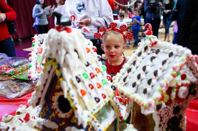 Sohayla Henry, 4, oohs and ahhs while admiring the gingerbread houses at the "We Knead the Dough" festival at Faith Lutheran School campus Saturday, December 8, 2012.